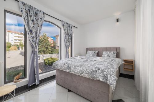 a bedroom with a bed and a large window at NOVA SPA - Sauna Suite for Two in Rijeka