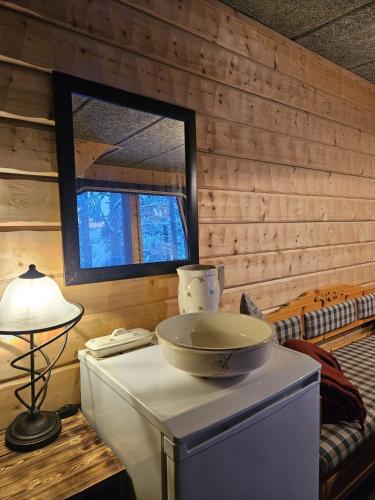 a room with a table with a bowl on top of it at The Lakeview Cabin in Kiruna