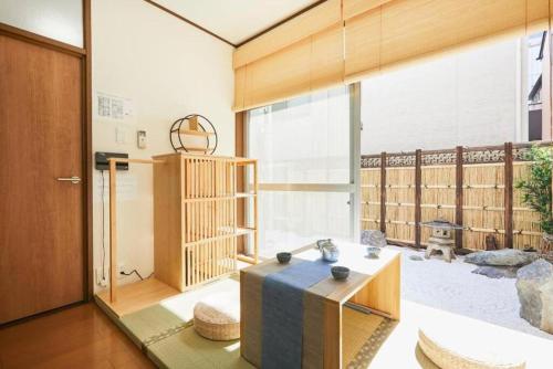 a living room with a table and a large window at Shinjuku area house with 3BR 2mins to Metro on foot in Tokyo