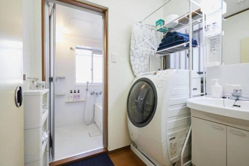 a bathroom with a washing machine and a sink at Shinjuku area house with 3BR 2mins to Metro on foot in Tokyo