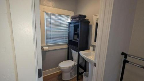 a small bathroom with a toilet and a sink at Studio Speedway in Tucson