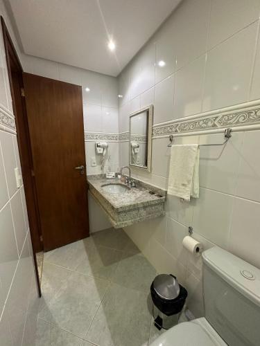 a bathroom with a sink and a toilet at Ecopousada Garten Haus in Santa Teresa
