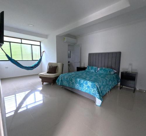 a bedroom with a bed and a hammock in it at Nuevo y Confortable Apartamento in Florencia