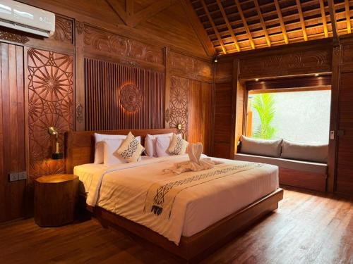 a bedroom with a large bed in a room at Wanataru Sidemen Villas in Sidemen