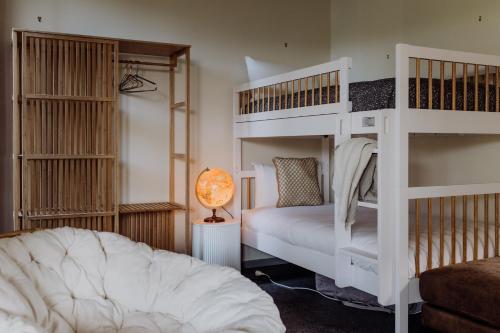a bedroom with two bunk beds and a lamp at Miramar Beach House in Seymour