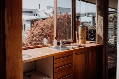 a kitchen with a sink and a window at Miramar Beach House in Seymour