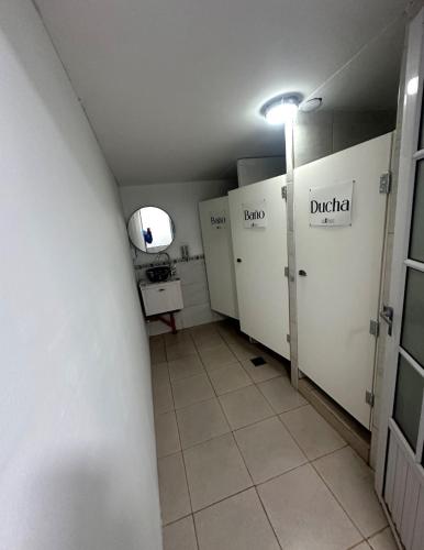 a bathroom with white lockers and a sink in it at Luxfran in Uspallata