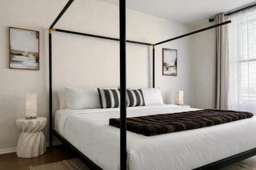 a bedroom with a large bed with a black frame at Beautiful Getaway Near Venice in Los Angeles
