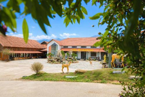 a house with two deer in front of it at Kolia Resort in Cao Bằng