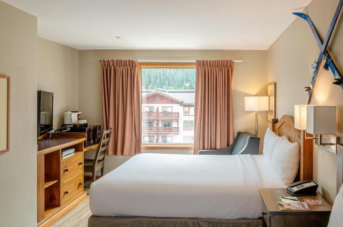 a hotel room with a bed and a window at Cahilty #302 in Sun Peaks