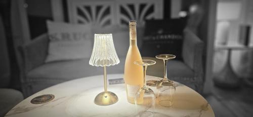 a table with a bottle and two glasses on it at The Hide Out in Belfast