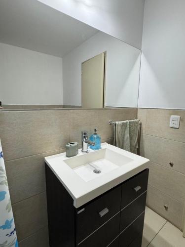 a bathroom with a white sink and a mirror at Dos D Point "pleno centro" in Río Tercero