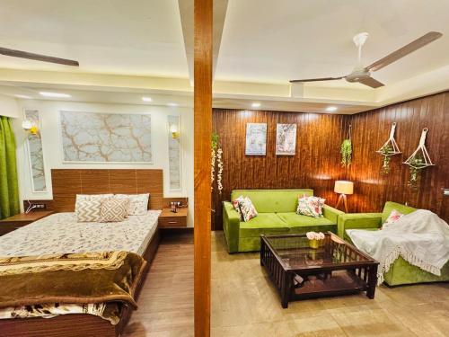 a living room with a bed and a couch at Studio in Dehradun in Dehradun