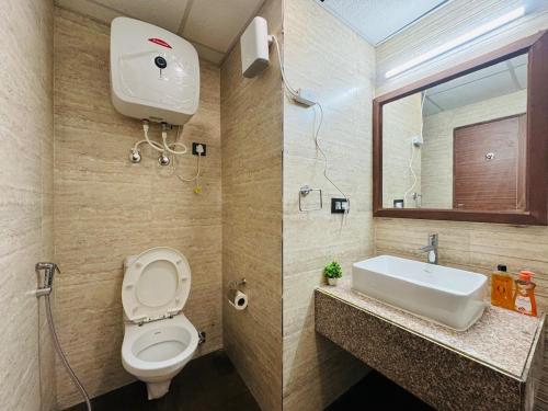 a bathroom with a toilet and a sink at Studio in Dehradun in Dehradun