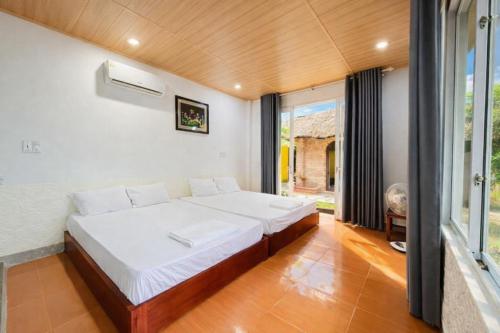 a bedroom with a large bed in a room at Newlife Homestay & Restaurant in Dong Hoi