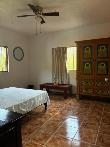 a bedroom with a bed and a ceiling fan at Casa El Limón in Yelapa