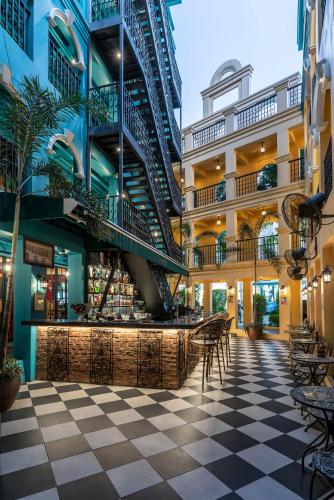 a lobby of a building with a bar and stairs at The Quba Boutique Hotel Pattaya in Pattaya