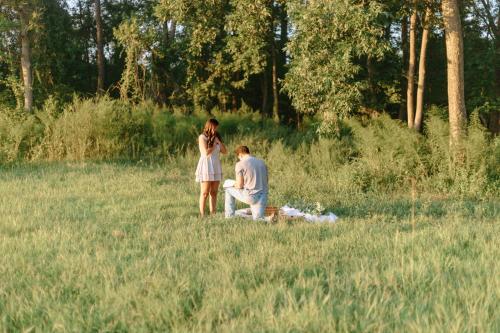 a man and a woman standing in a field at The Barn Apartment at Parkton Place in Hope Mills