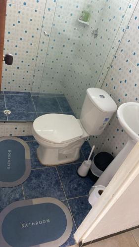 a bathroom with a toilet and a sink at Habitaciones cama doble in La Vega