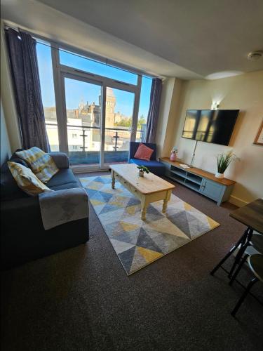 a living room with a couch and a coffee table at Castle View Apartment, Cardiff City Centre in Cardiff