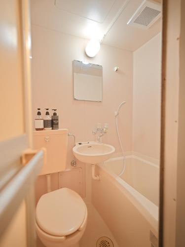 a bathroom with a toilet and a sink and a tub at The Nest Koenji Cozy Stay near Station Easy Access to Shinjuku in Tokyo