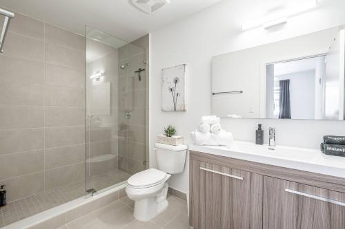 a bathroom with a toilet and a shower and a sink at Prime 2BR Location Near Miami FIFA World Cup Stadium - Private Parking - EV Station in Hallandale Beach
