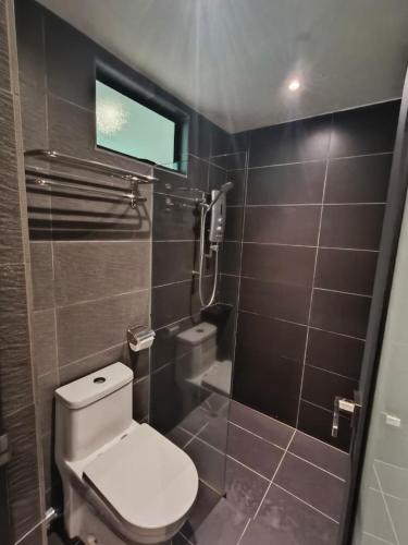 a small bathroom with a toilet and a window at Lilla Waterfall Retreat - Sg Lembing, Kuantan Formerly Known as Casa Hill Resort in Sungai Lembing