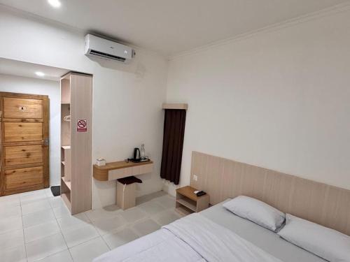 a hotel room with a bed and a bathroom at G-House-2 in Singkawang