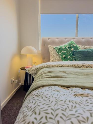 a bedroom with a bed with a large window at 3-Bedroom Modern Home in Clyde North in Clyde North