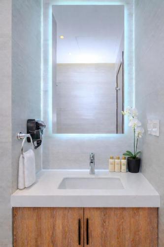 a bathroom with a sink and a mirror at Stella Stays King Fahd - Furnished Apartments in Riyadh