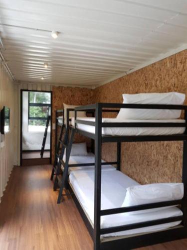 a group of bunk beds in a room at Lilla Waterfall Retreat - Sg Lembing, Kuantan Formerly Known as Casa Hill Resort in Sungai Lembing