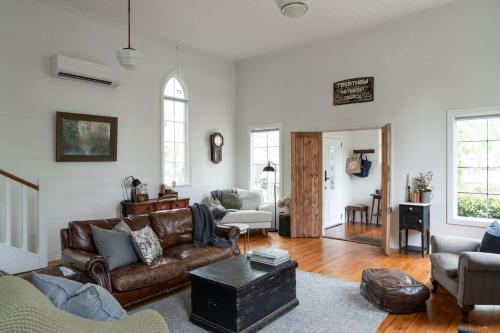 a living room with a couch and a table at The Old Trentham Church in Trentham