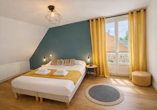a bedroom with a large bed and a large window at White House Dhavernas - Résidence Privée - Amiens - Parking Gratuit in Amiens