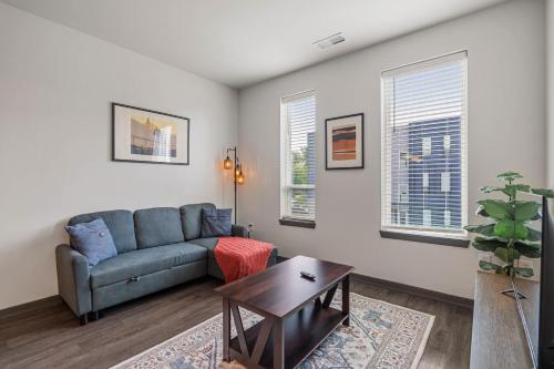 a living room with a couch and a table at CozySuites AYR in Indianapolis