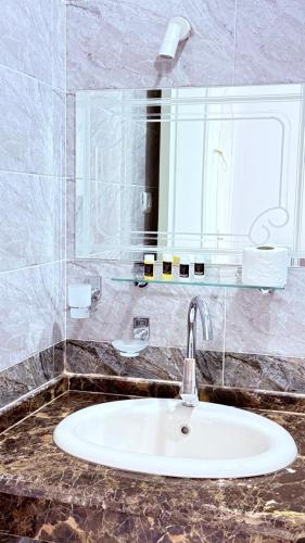 a bathroom counter with a sink and a mirror at Panorama Hotel in Luxor