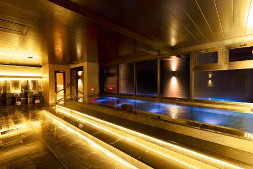 a swimming pool in a building at night at TAOYA Hakone in Hakone