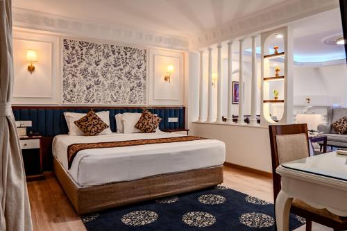 a hotel room with a bed and a desk at Maya Manor Boutique Hotel - A Restored Heritage Mansion in the Heart of Kathmandu in Kathmandu