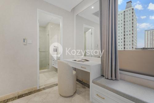 a white bathroom with a desk and a window at Rosen by Kozystay - Thamrin in Jakarta