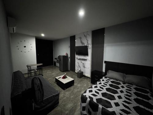 a bedroom with a bed and a couch and a table at Loft en tequila Jalisco in Tequila