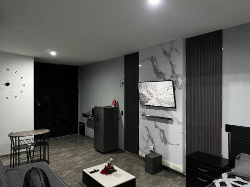 a living room with a refrigerator and a table at Loft en tequila Jalisco in Tequila