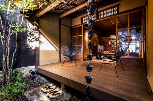 two chairs and flip flops on a wooden deck at Rinn Kyoto Imperial Palace South Kishoan in Kyoto