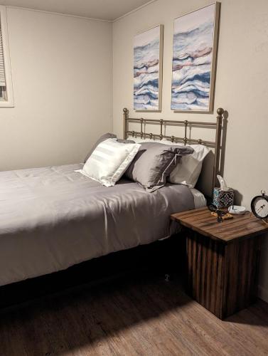 a bedroom with a bed and a wooden table at The Gate City Grande in Pocatello