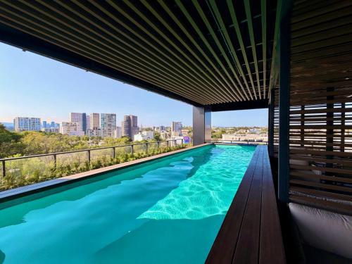 a swimming pool with a view of the city from a building at Departamento Elysian High Country in Guadalajara