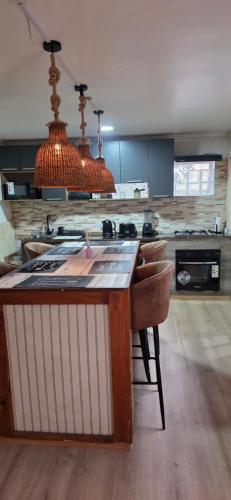 a kitchen with a island in the middle of a room at Maitencillo Shelter in Puchuncaví