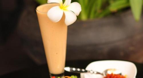 a vase with a flower on top of a table at Glorious Hotel in Kompong Thom