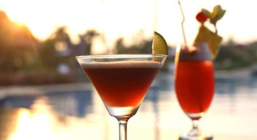 two cocktails sitting on top of a table at Glorious Hotel in Kompong Thom