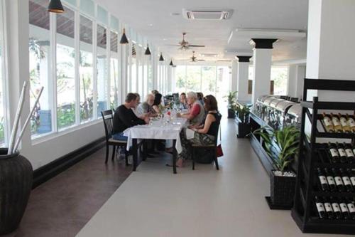 a group of people sitting at a table in a restaurant at Glorious Hotel in Kompong Thom