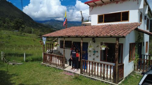 a woman standing in the doorway of a house at Mirador De Las Pirámides in Zetaquira