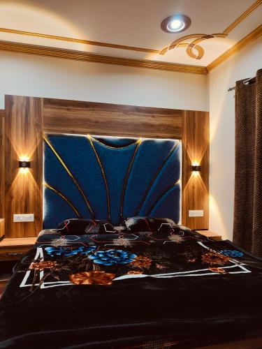 a bedroom with a bed with a blue head board at The Sapphire Retreat in Srinagar