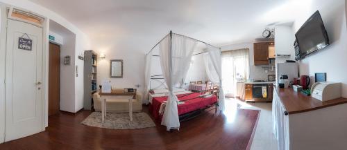 a bedroom with a bed with a canopy at Appartamento Levante in Lido di Ostia